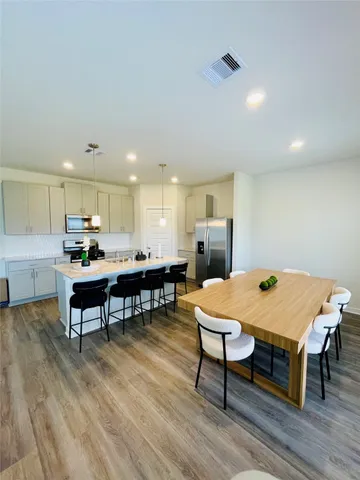 a view of a dining room with furniture and wooden floor