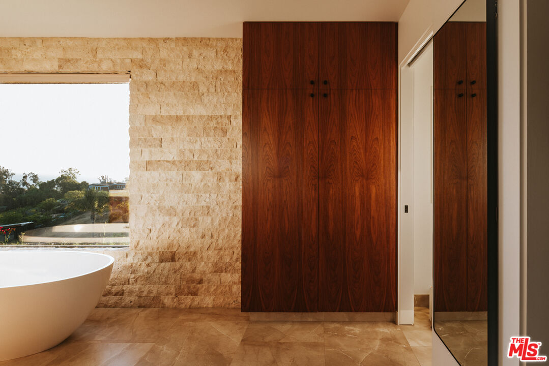 29660 Harvester Road Malibu, CA 90265 - Photo 14 of 45 a bathroom with a bathtub and shower