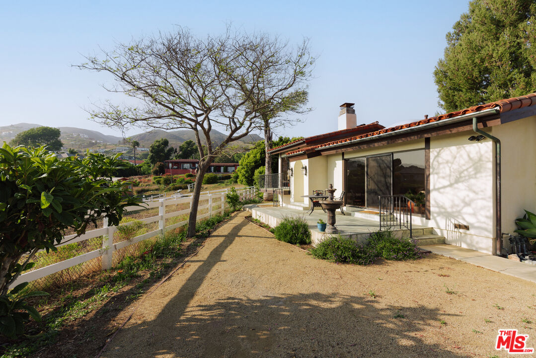 29660 Harvester Road Malibu, CA 90265 - Photo 24 of 45 a view of a house with backyard and sitting area