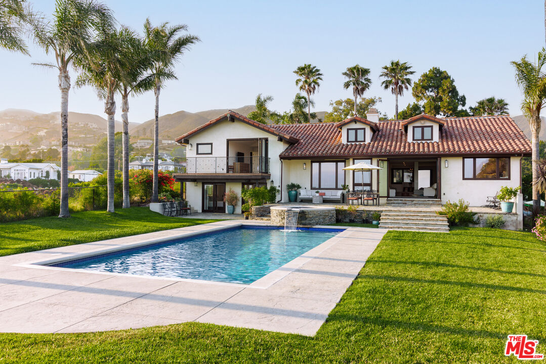 29660 Harvester Road Malibu, CA 90265 - Photo 35 of 45 a view of a house with a swimming pool