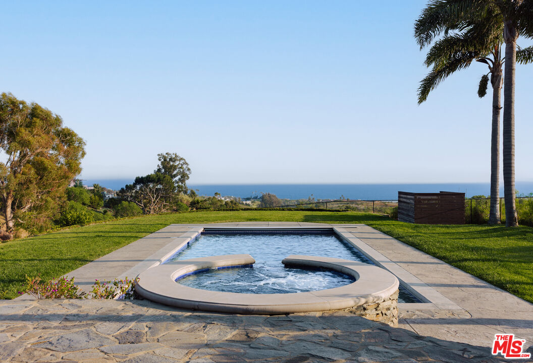 29660 Harvester Road Malibu, CA 90265 - Photo 36 of 45 a swimming pool with outdoor seating and yard