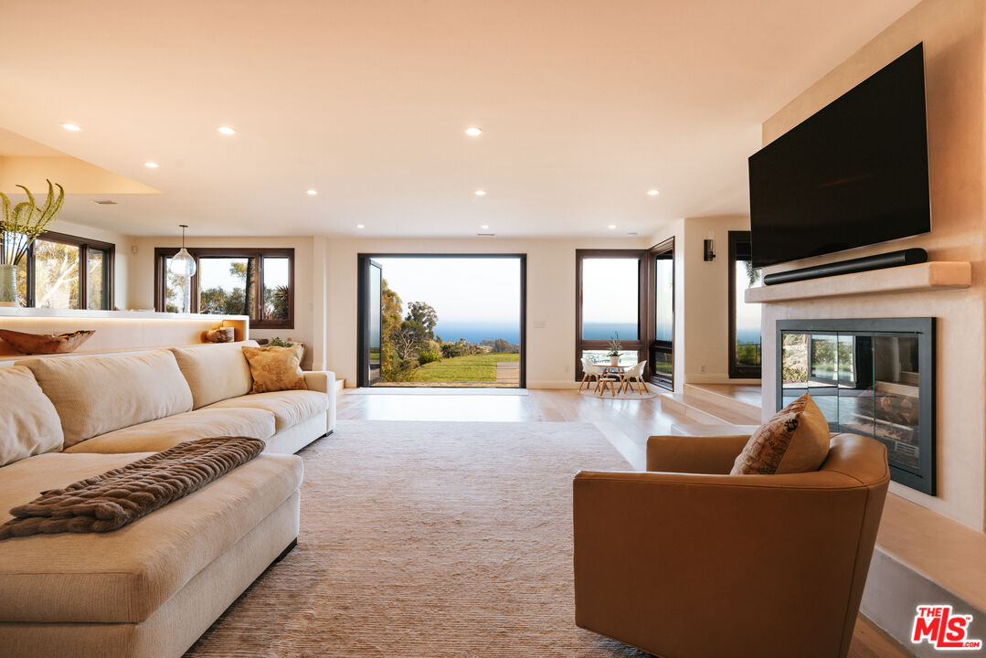 29660 Harvester Road Malibu, CA 90265 - Photo 7 of 45 a living room with furniture and a flat screen tv