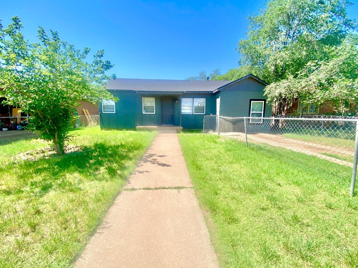 517 54th Street Lubbock, TX 79404 - Photo 1 of 16 a front view of a house with a yard and trees