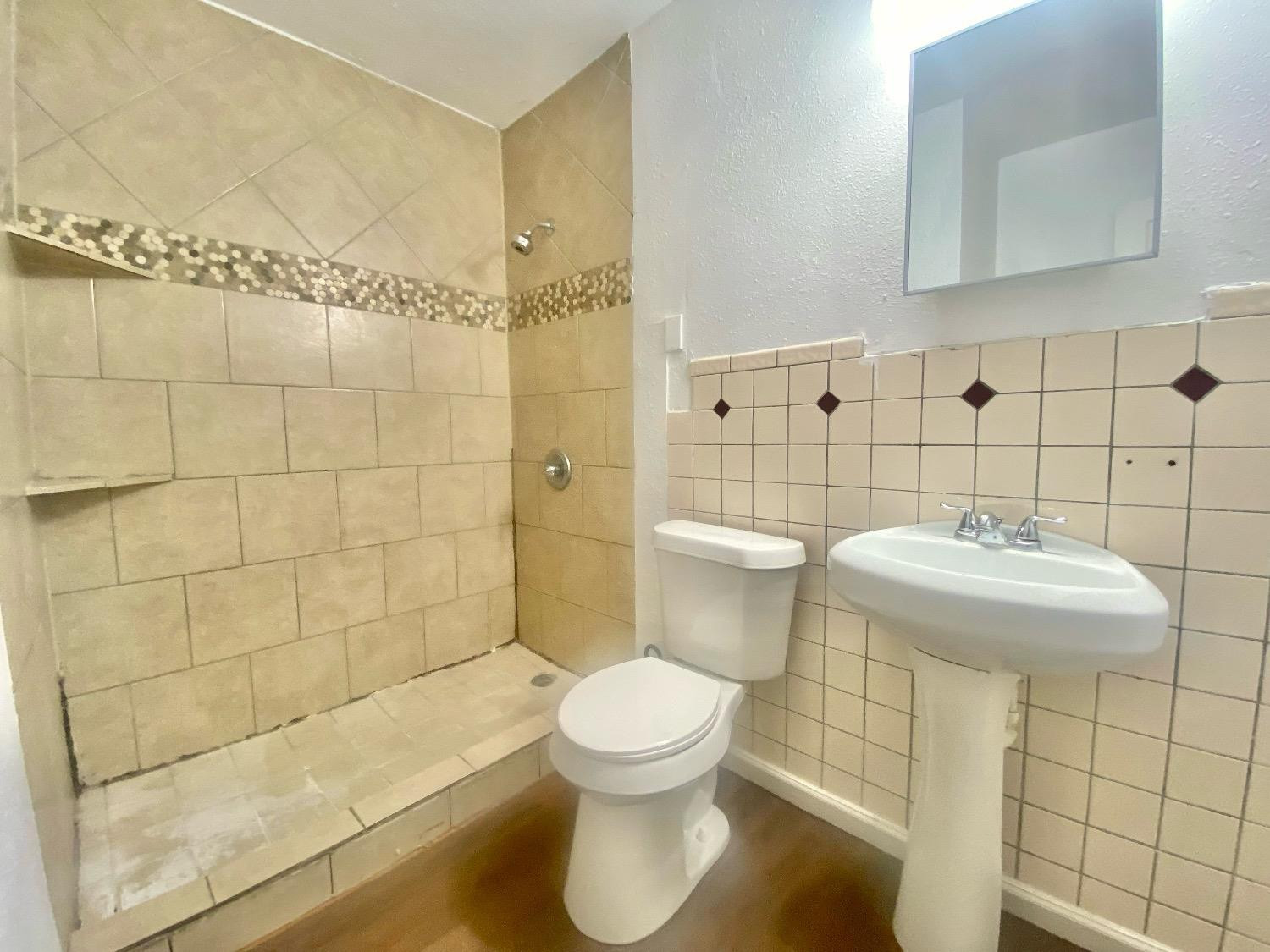 517 54th Street Lubbock, TX 79404 - Photo 11 of 16 a bathroom with a toilet and a sink
