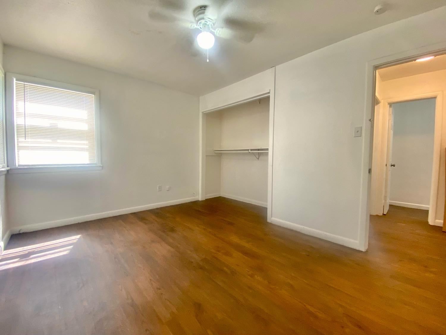 517 54th Street Lubbock, TX 79404 - Photo 13 of 16 an empty room with wooden floor and windows