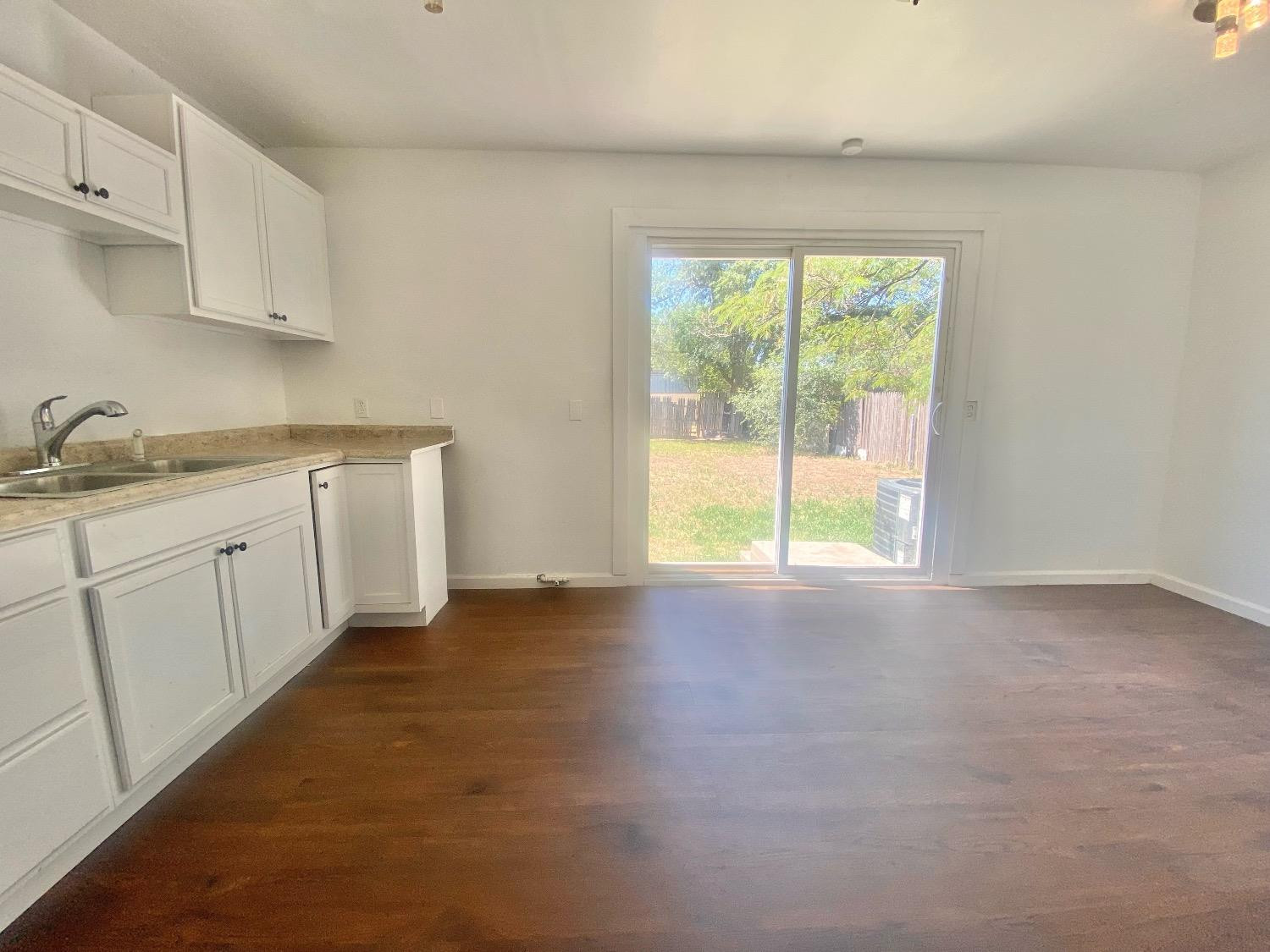 517 54th Street Lubbock, TX 79404 - Photo 6 of 16 a kitchen with a sink a window and cabinets