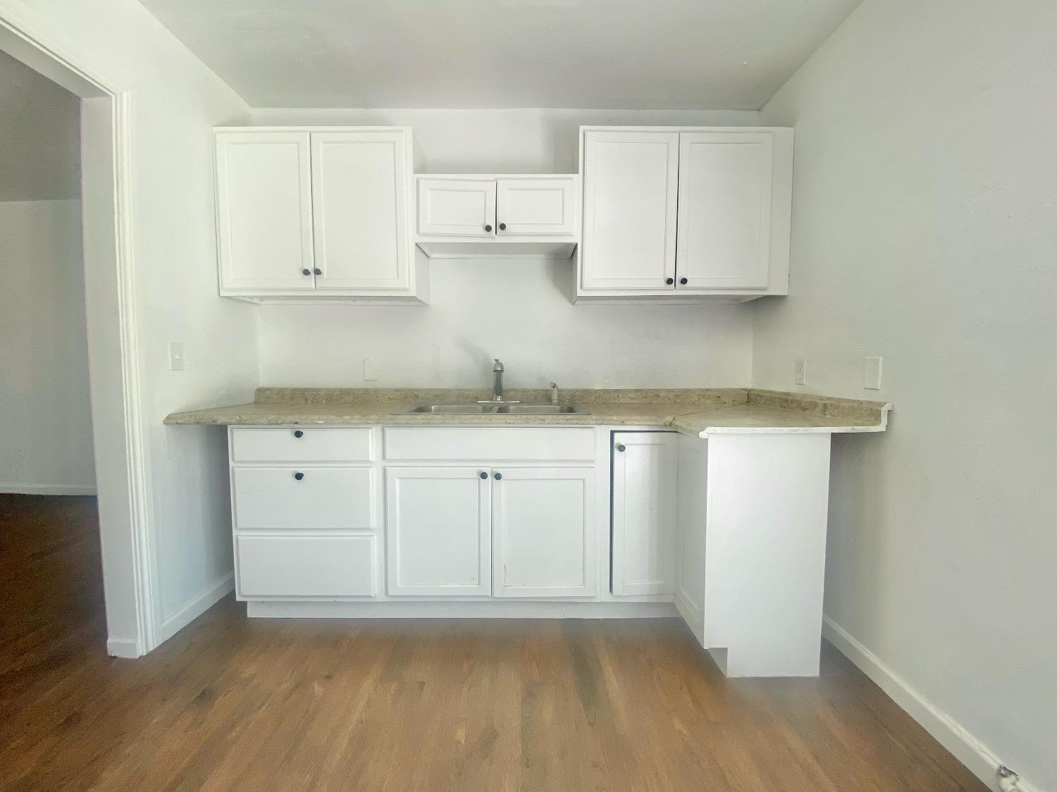 517 54th Street Lubbock, TX 79404 - Photo 7 of 16 a view of cabinets with wooden floor