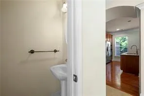 a view of a hallway with wooden floor and furniture