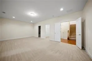 an empty room with closet and natural light
