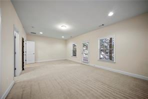 2829 Seneca Creek Lane, Unit 3 Marietta, GA 30067 - Photo 20 of 23 an empty room with staircase and a bathroom