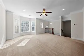 a view of a livingroom with a ceiling fan and window
