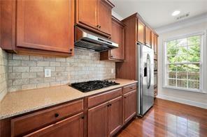 2829 Seneca Creek Lane, Unit 3 Marietta, GA 30067 - Photo 10 of 23 a kitchen with stainless steel appliances granite countertop a stove a sink and a microwave