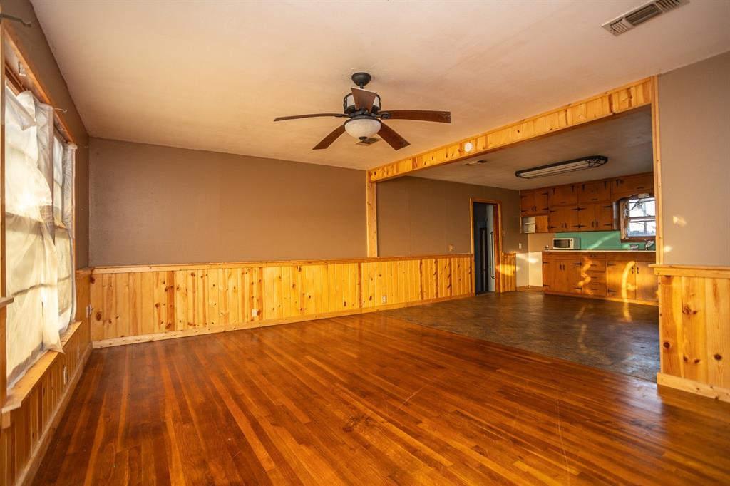 1414 Rice Avenue Gainesville, TX 76240 - Photo 8 of 21 a view of empty room with wooden floor and fan