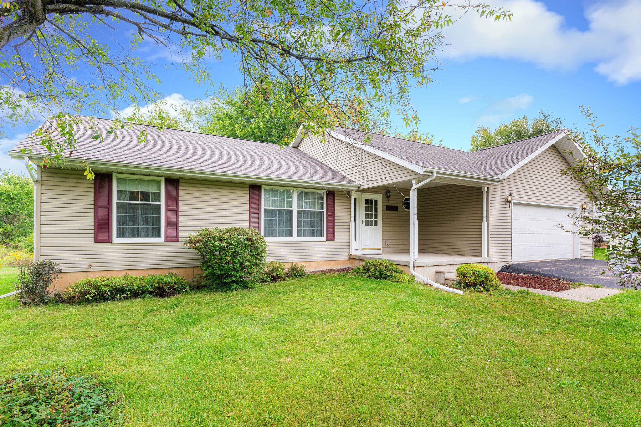 a view of a house with a yard and sitting area
