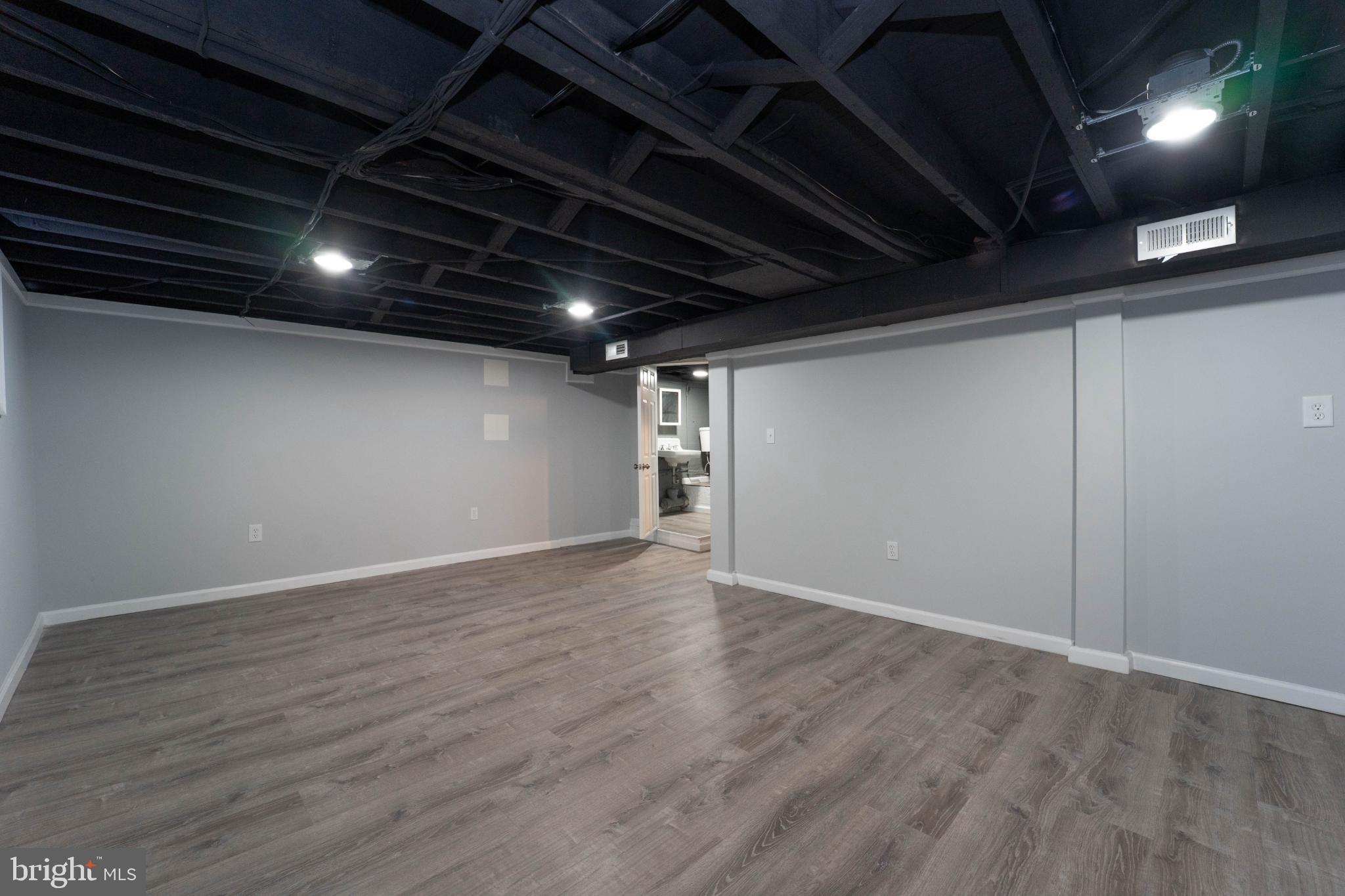 5312 Catalpha Road Baltimore, MD 21214 - Photo 27 of 59 a view of an empty room with wooden floor