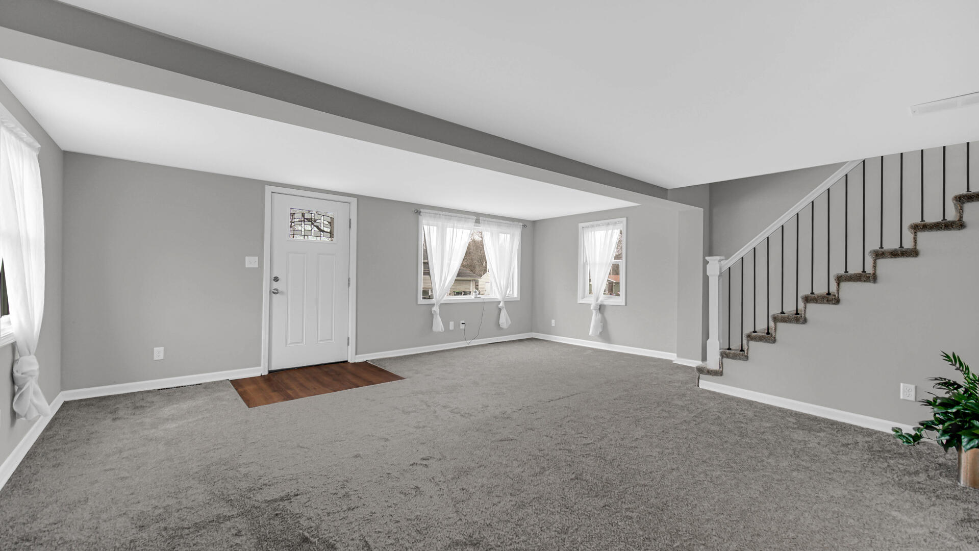 337 North Dearborn Street Hobart, IN 46342 - Photo 3 of 19 a view of an empty room with stairs and a window