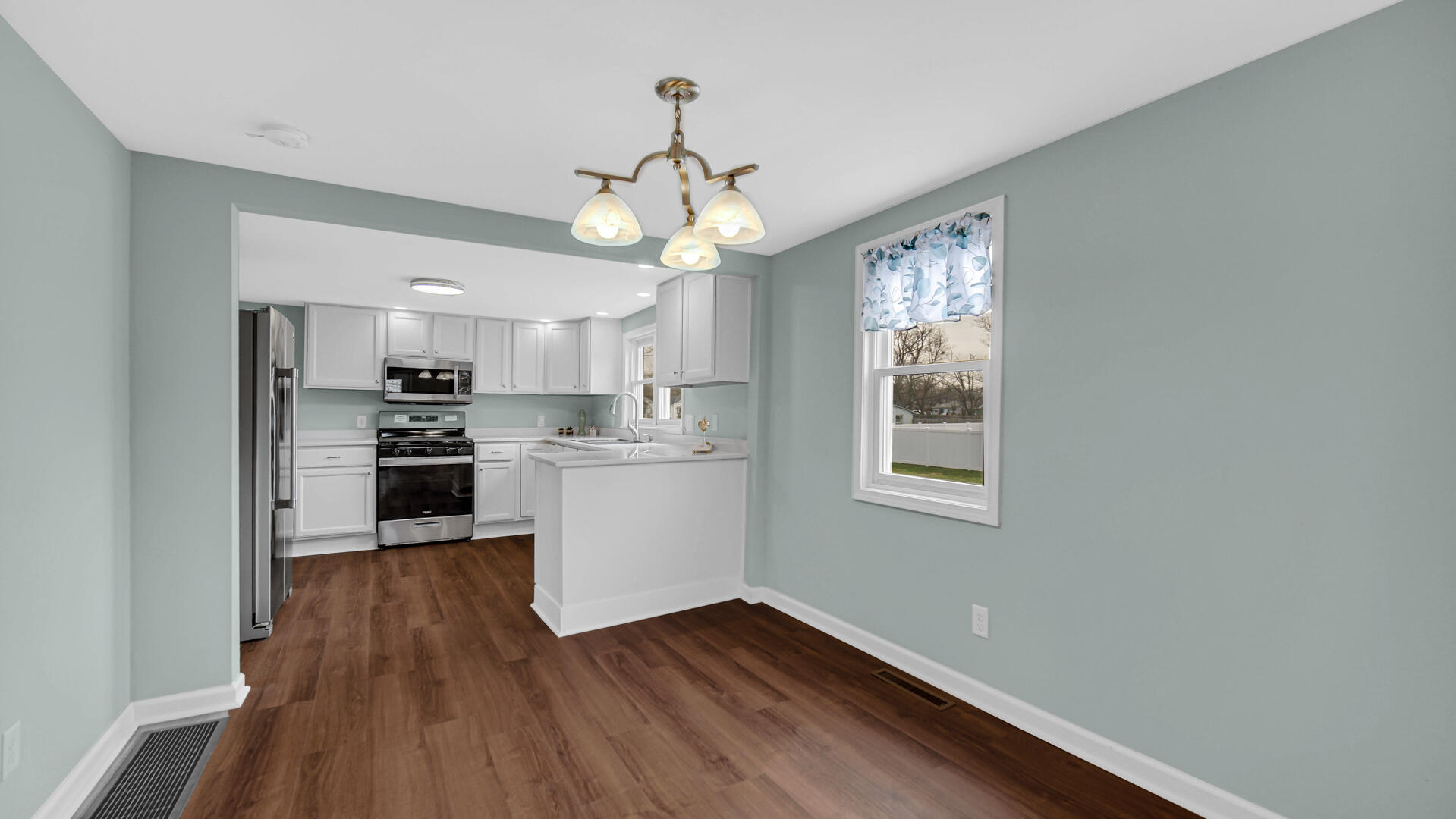 337 North Dearborn Street Hobart, IN 46342 - Photo 6 of 19 a view of a kitchen with wooden floor and stainless steel appliances