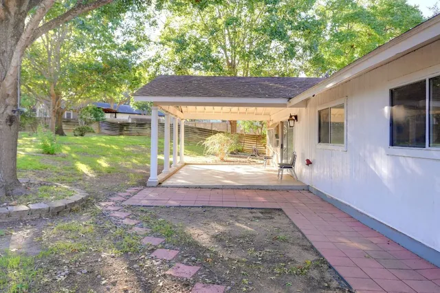a view of house with backyard