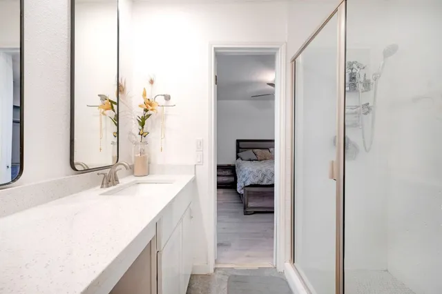 a en suite bathroom with a sink and a mirror