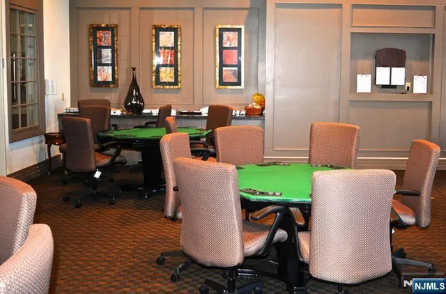 a living room with furniture a wine shelf and wine cellar