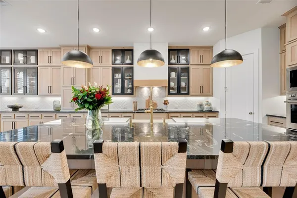 a kitchen with stainless steel appliances kitchen island granite countertop a table and chairs