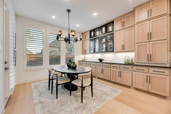 a kitchen with granite countertop cabinets table and chairs