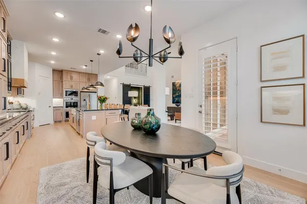a view of a dining room with furniture and a kitchen