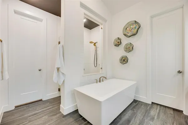 a white bath tub sitting next to a white sink