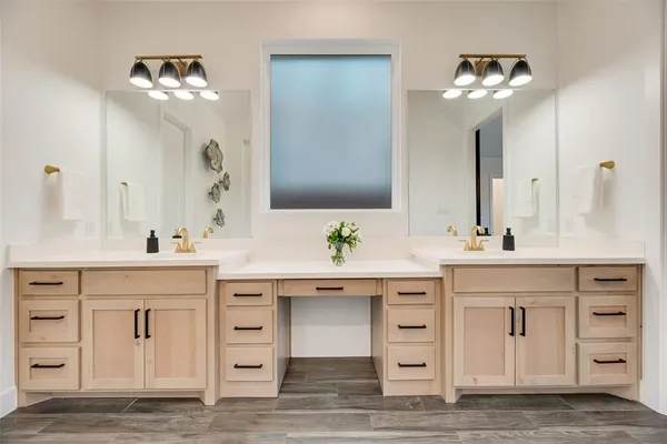 a bathroom with a sink vanity and a mirror