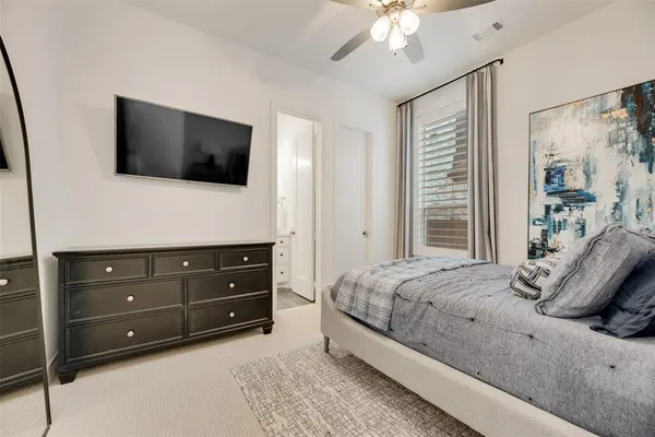 a bedroom with a bed a window and a television