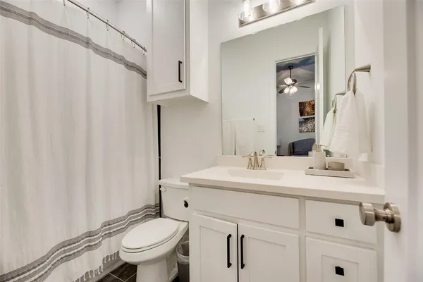a bathroom with a sink toilet and mirror