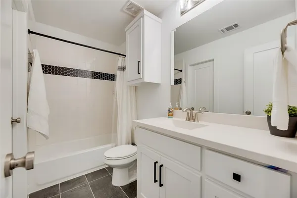 a bathroom with a sink toilet tub and shower
