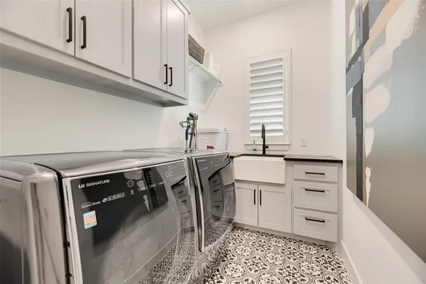 a kitchen with a sink a stove and cabinets