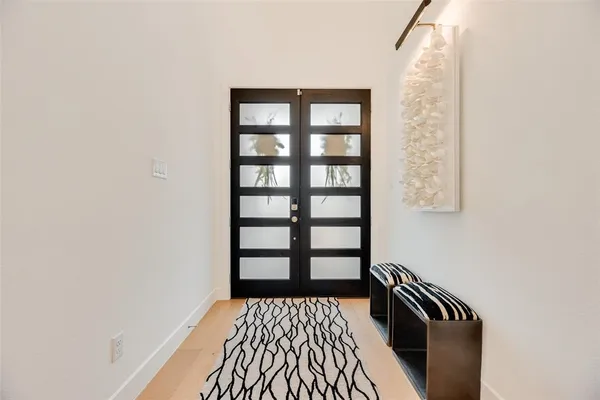 a view of a room with wooden floor and a window