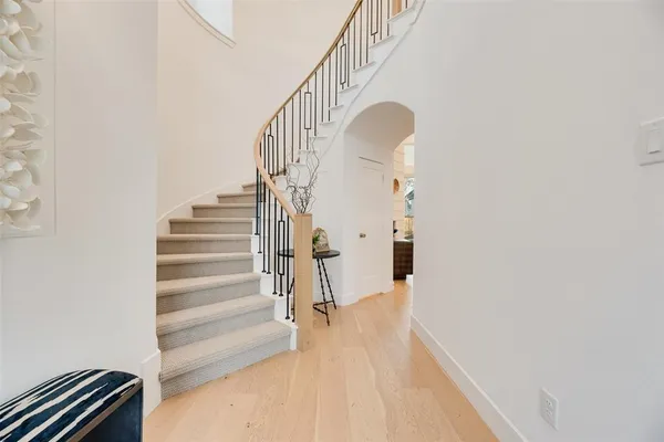 a view of entryway and hall with wooden floor