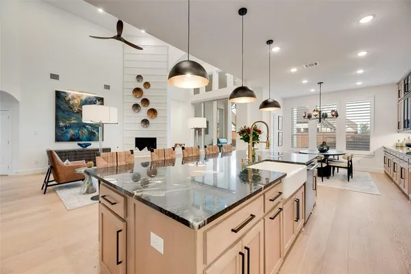 a kitchen with stainless steel appliances granite countertop a stove and a wooden floors