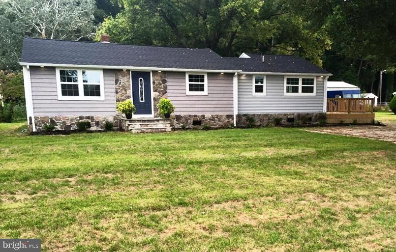 12207 Line Road Delmar, DE 19940 - Photo 1 of 23 a front view of a house with a garden
