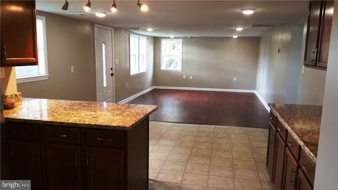 12207 Line Road Delmar, DE 19940 - Photo 2 of 23 a kitchen with kitchen island granite countertop a sink and a stove