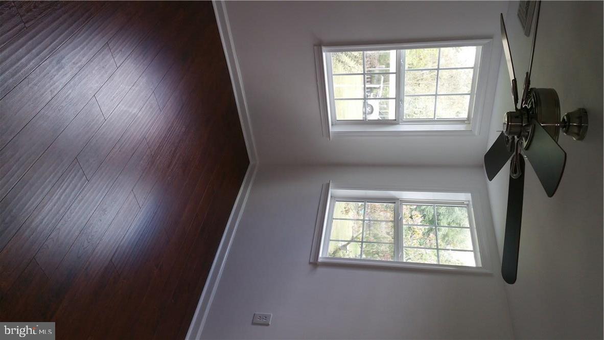 12207 Line Road Delmar, DE 19940 - Photo 14 of 23 an empty room with wooden floor and windows