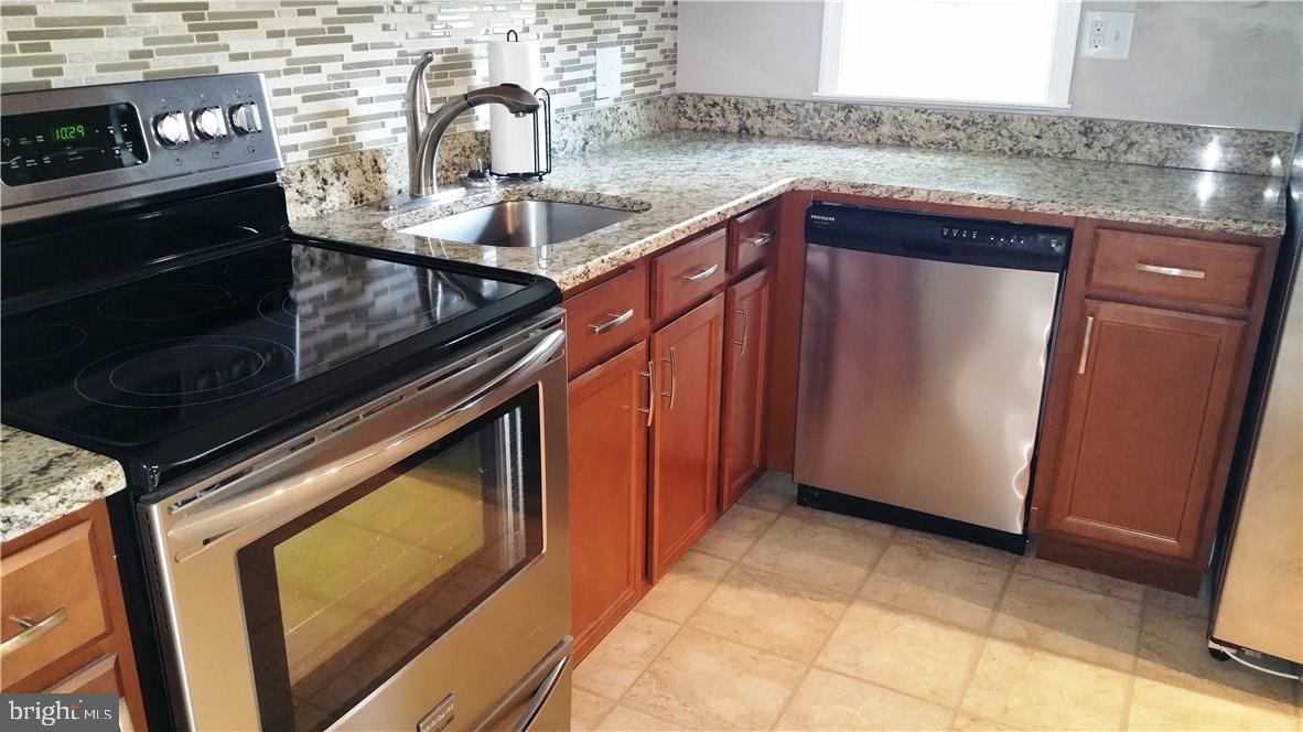12207 Line Road Delmar, DE 19940 - Photo 3 of 23 a kitchen with a sink and cabinets
