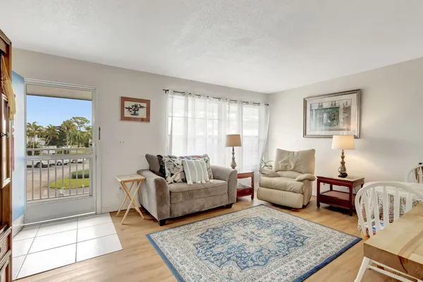 a living room with furniture rug and window