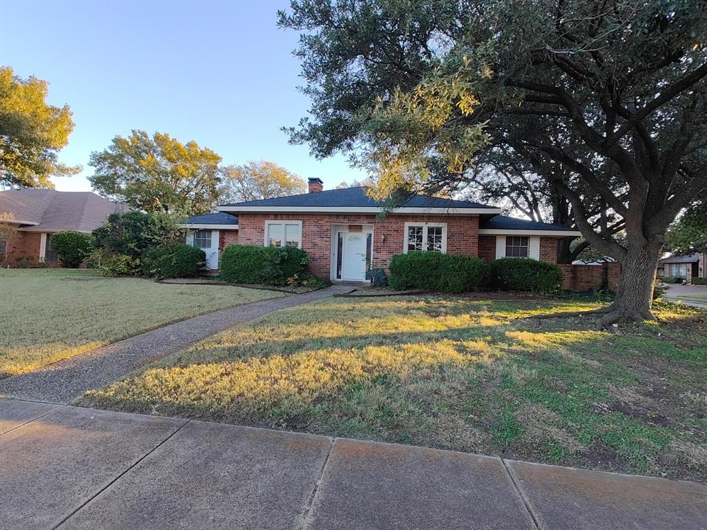 2012 Cross Bend Road Plano, TX 75023 - Photo 1 of 11 a front view of a house with a yard