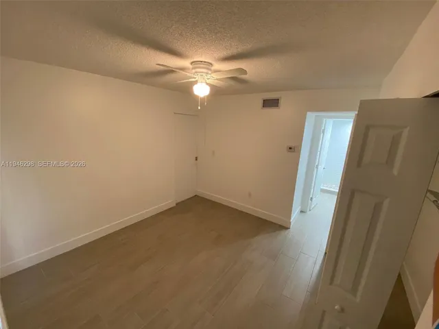 an empty room with a empty space and a ceiling fan