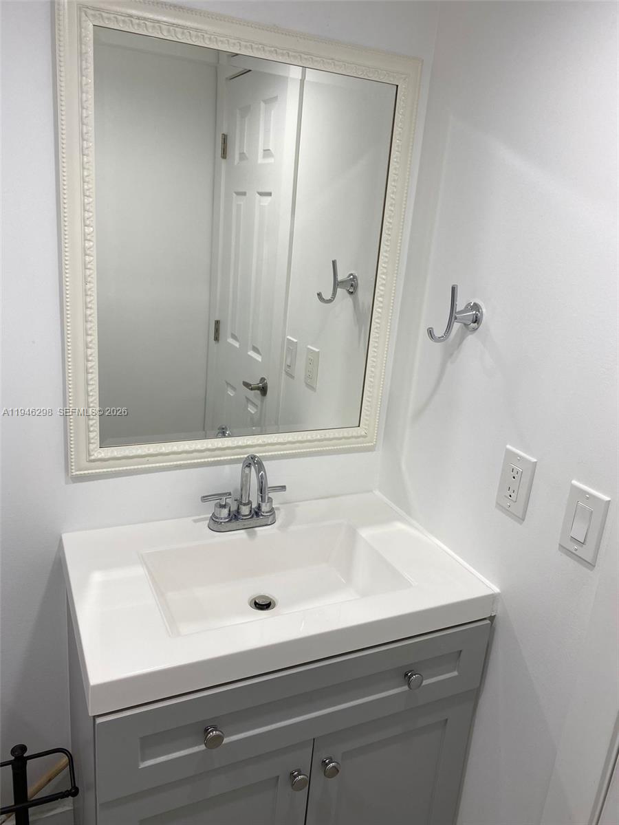4805 Northwest 7th Street, Unit 10315 Miami, FL 33126 - Photo 14 of 22 a bathroom with a sink and a mirror