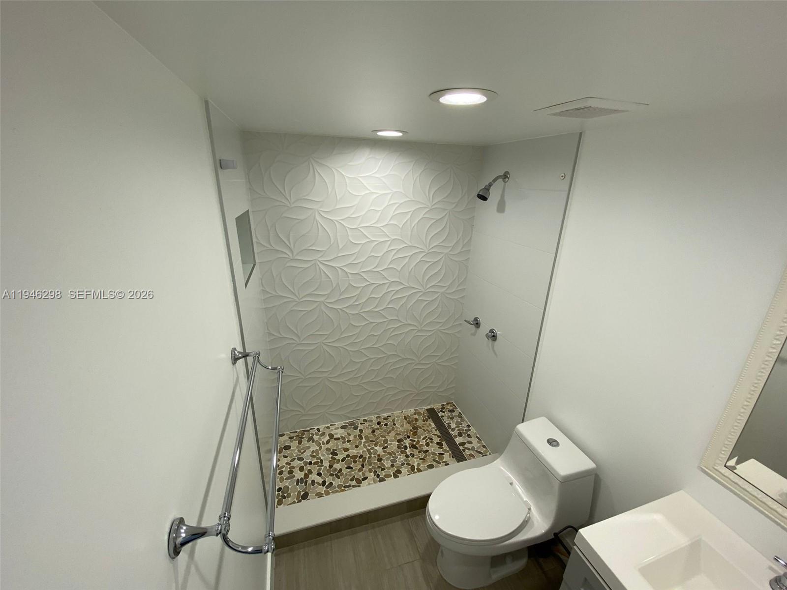 4805 Northwest 7th Street, Unit 10315 Miami, FL 33126 - Photo 15 of 22 a bathroom with a toilet and a shower