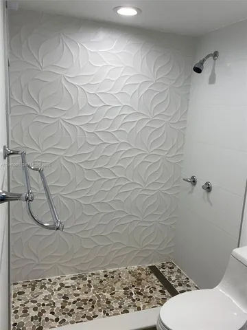 a bathroom with a toilet and a shower