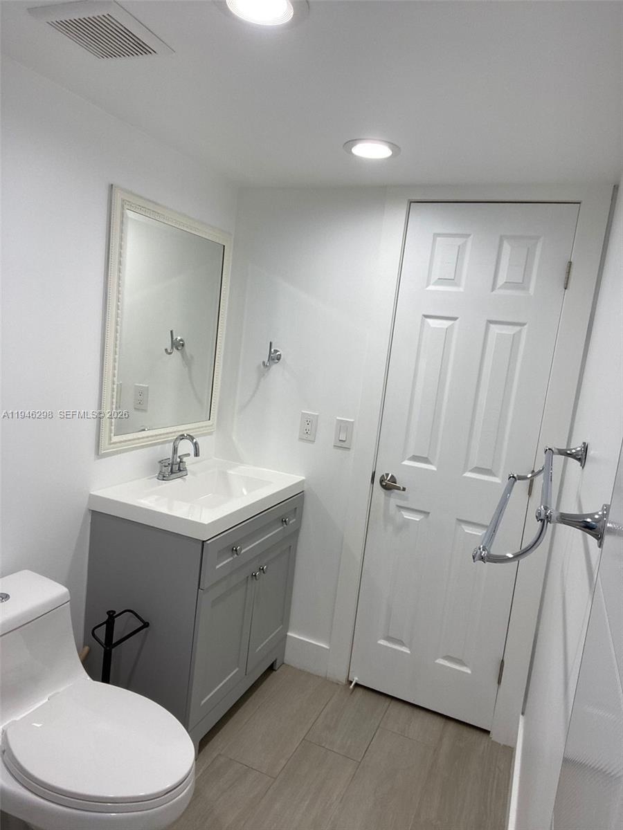 4805 Northwest 7th Street, Unit 10315 Miami, FL 33126 - Photo 17 of 22 a bathroom with a sink a toilet and shower