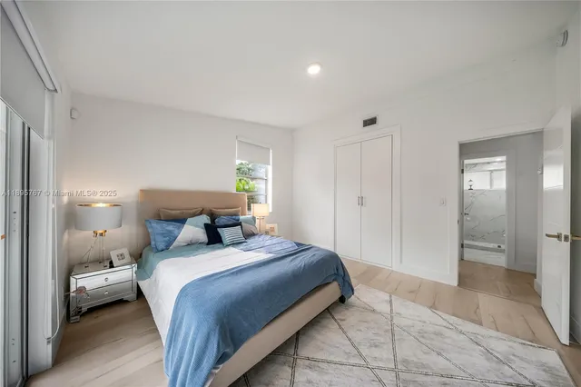 a bedroom with a bed and a lamp