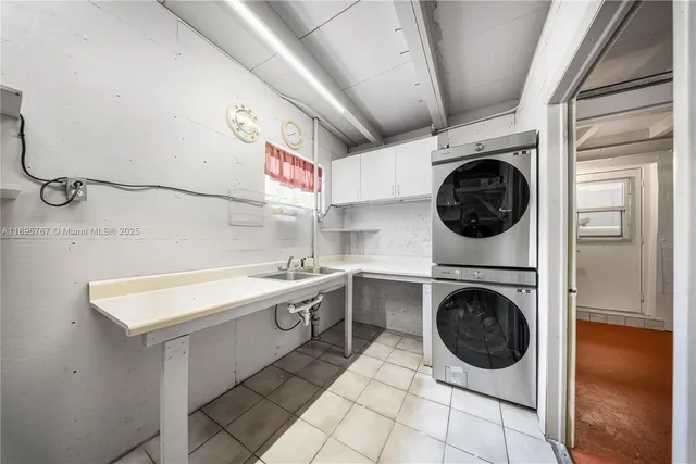 a utility room with sink dryer and washer