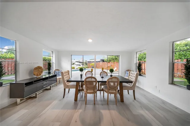 a view of a dining room with furniture and wooden floor